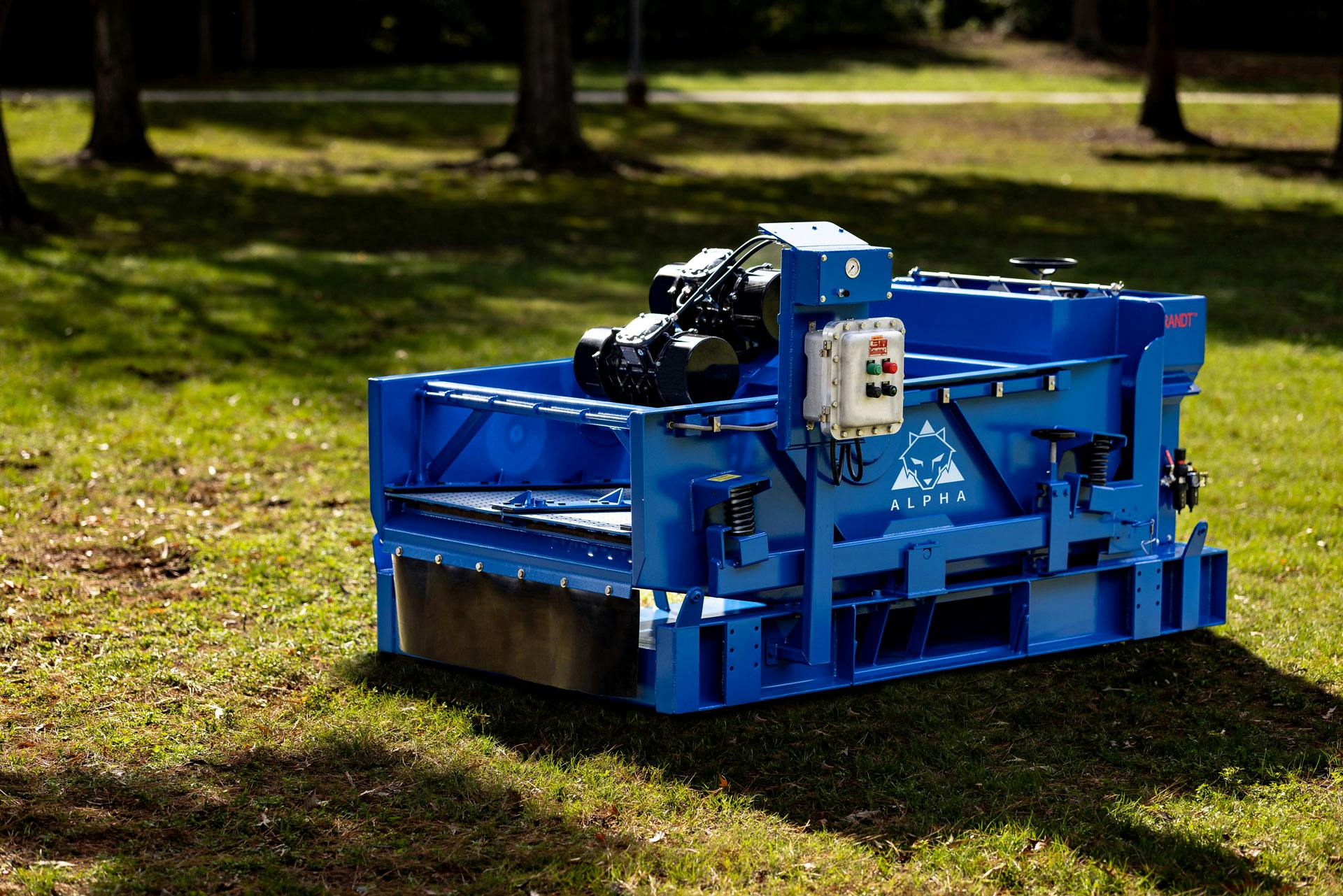 Top angled shot of an Alpha Shaker, with the logo, on a field