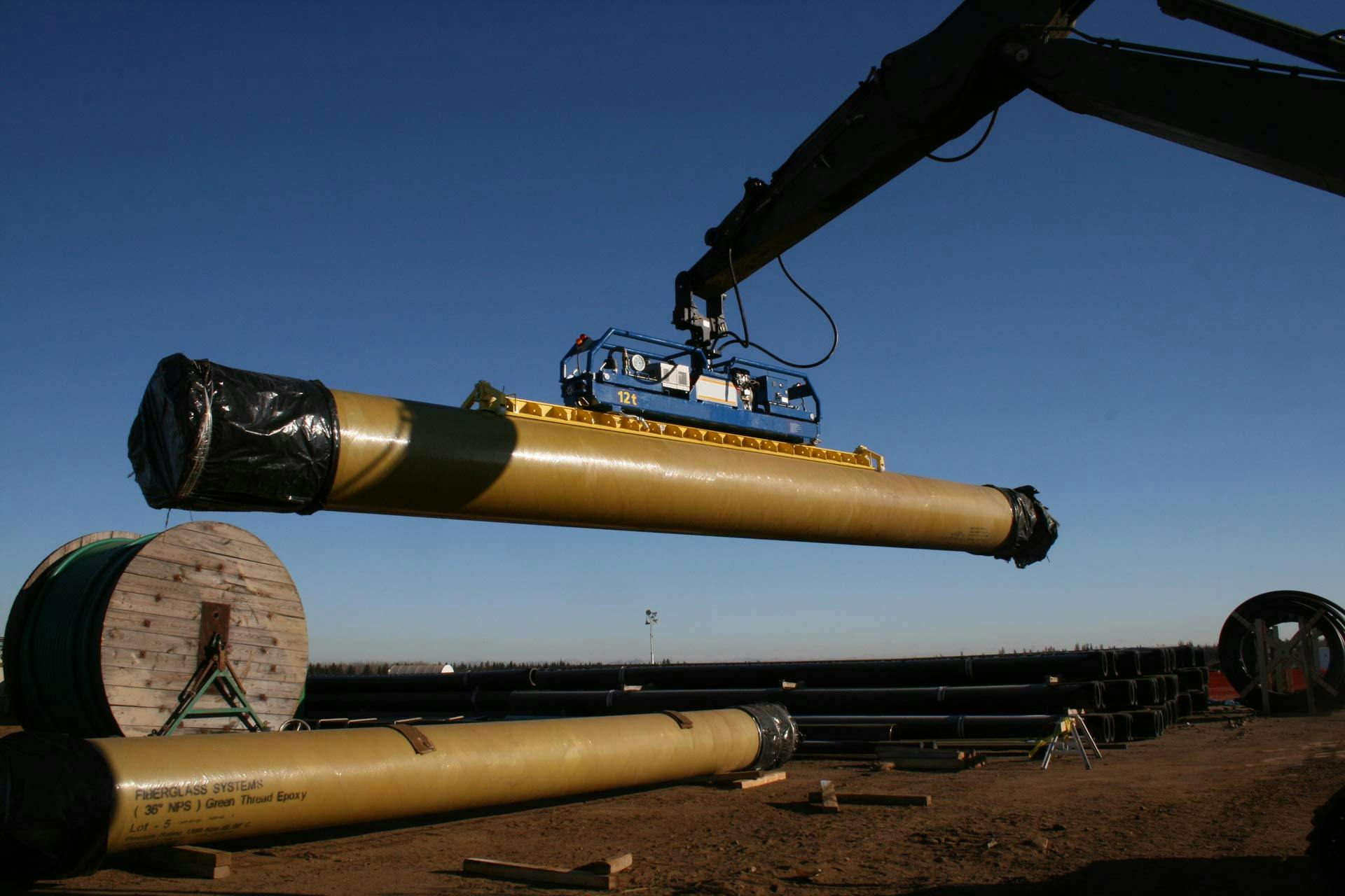 Machinery picks up a line of composite pipe