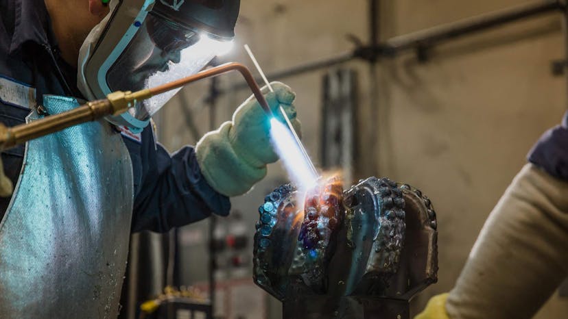 Drill bit being created in a NOV manufacturing facility