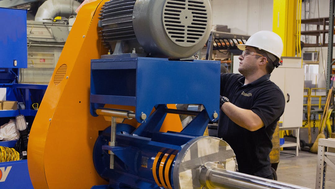 Close image of an NOV employee with a Prochem mixer in a manufacturing facility