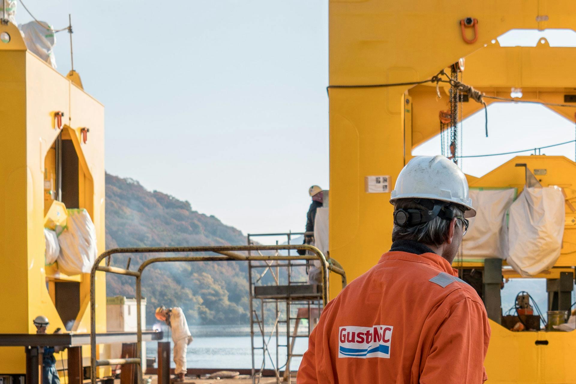 NOV employee wearing PPE looking at offshore engineering equipment