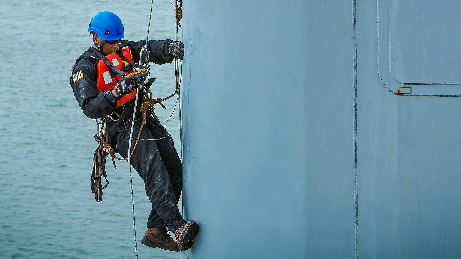 Technician performing an offshore derrick inspection