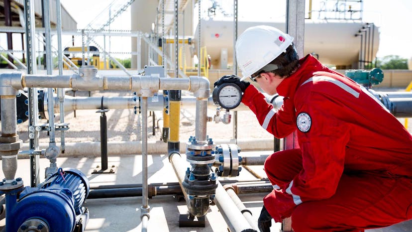 Saltwater disposal technician working on equipment