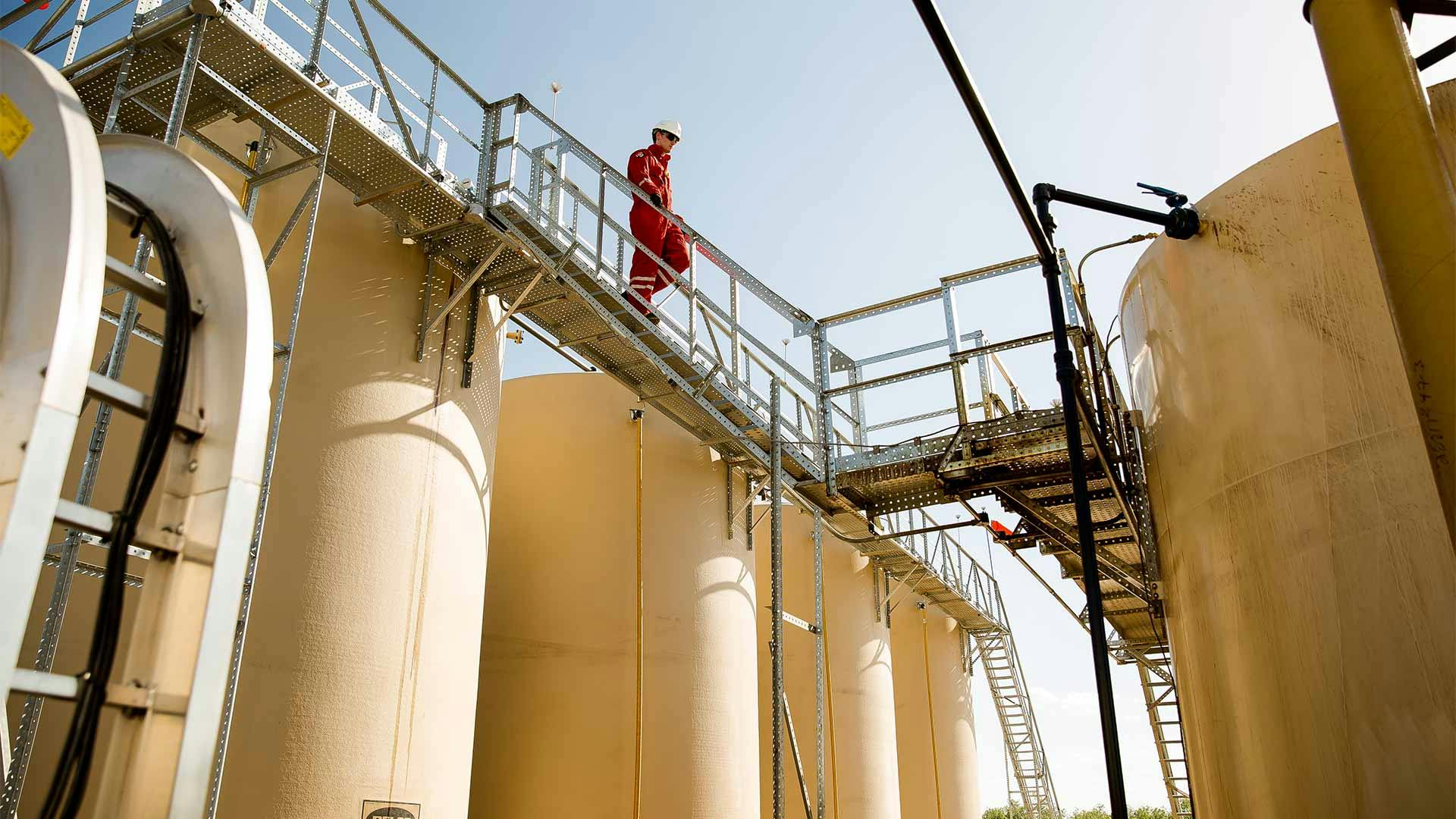 technician examining an onshore production site