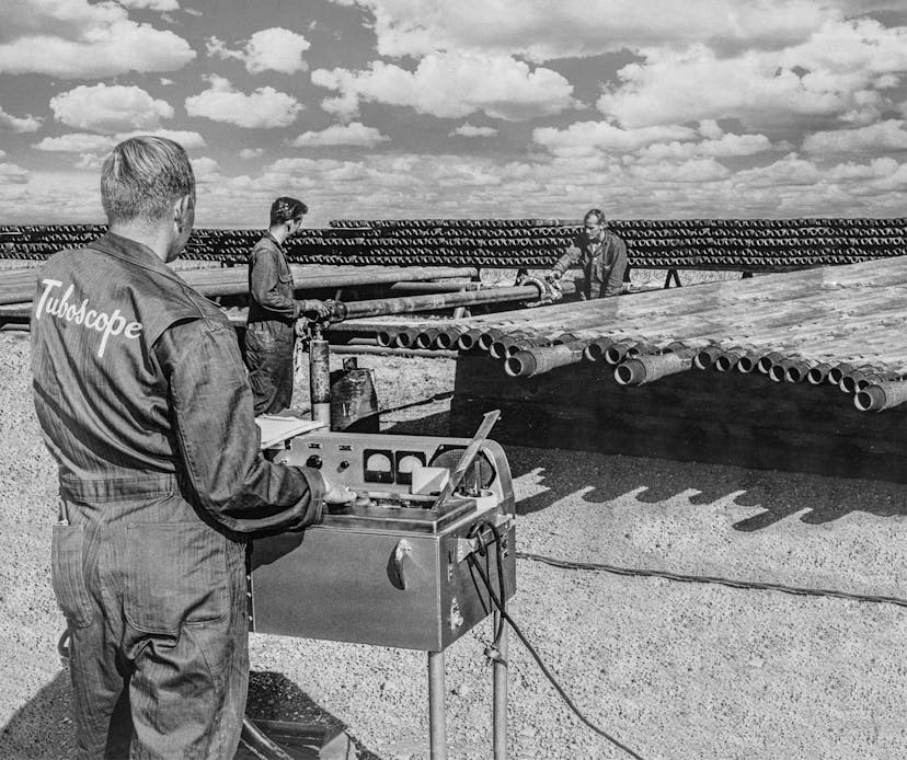 Vintage image of Tuboscope employees performing pipe inspections