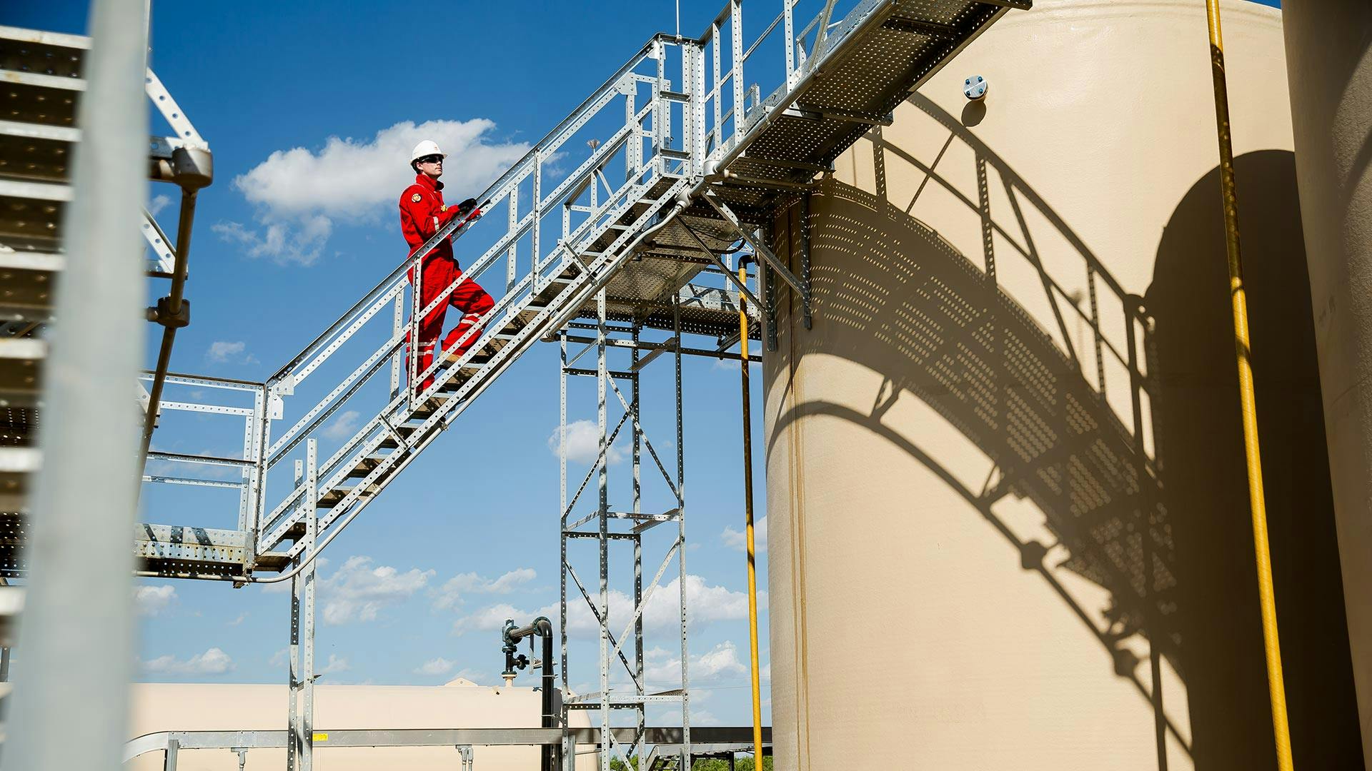 Wellstream technician climbing stairs